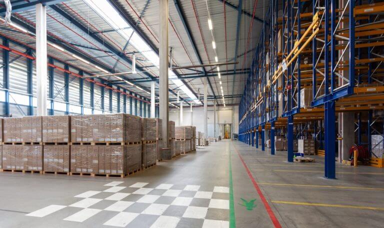 Warehouse loading area with pallet racks and stored inventory